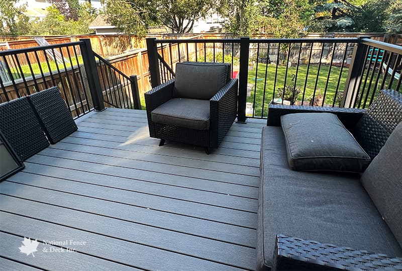 Trex Clam Shell deck with PVC lattice skirting and custom 4"x4" post railings.