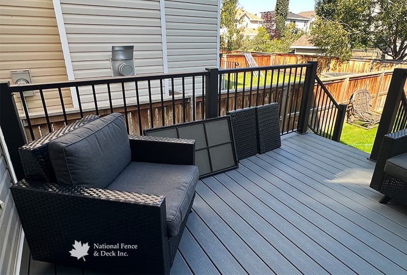 Trex Clam Shell deck with PVC lattice skirting and custom 4"x4" post railings.