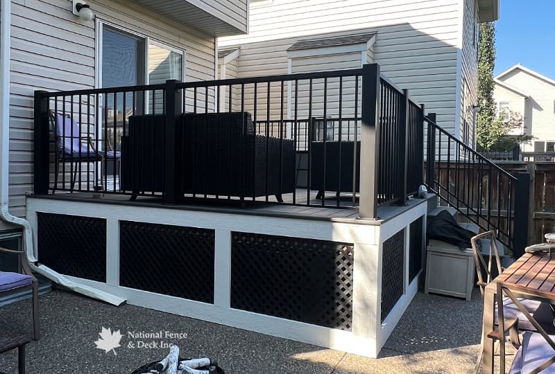 Trex Clam Shell deck with PVC lattice skirting and custom 4"x4" post railings.