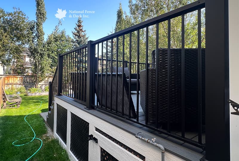 Trex Clam Shell deck with PVC lattice skirting and custom 4"x4" post railings.