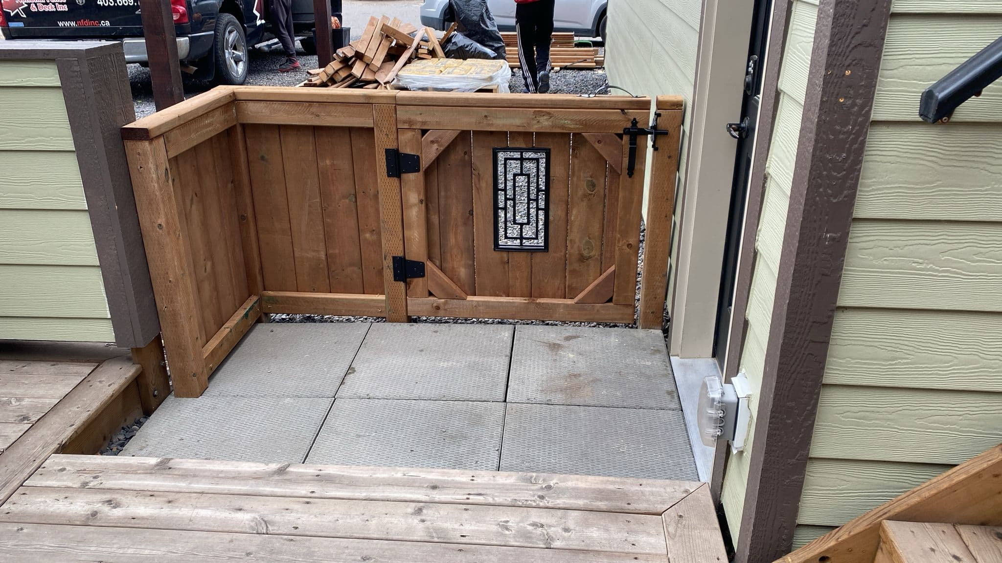 Interior view of a custom cedar gate with decorative glass and black hardware.
