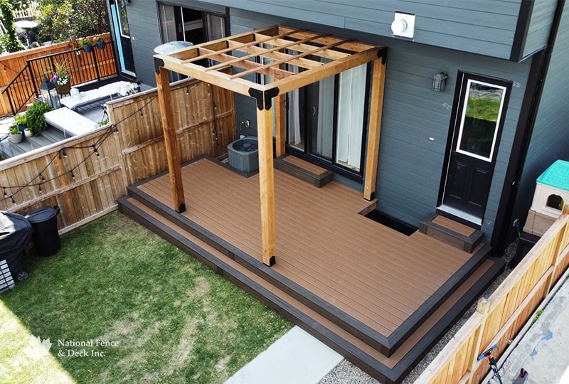 Cedar pergola with composite decking in a backyard outdoor living space.