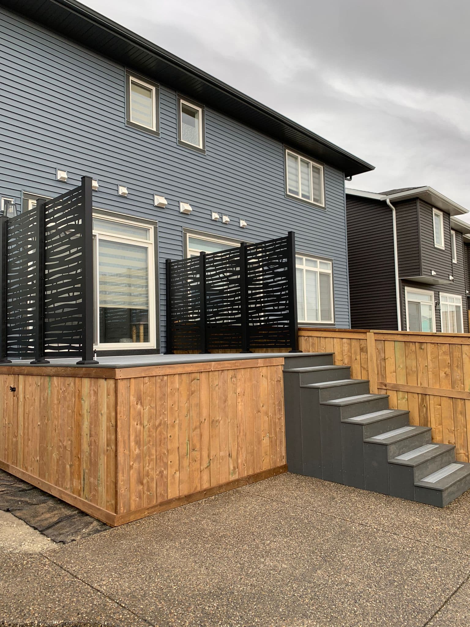 Vinyl deck installation in Calgary with privacy screen and stairs