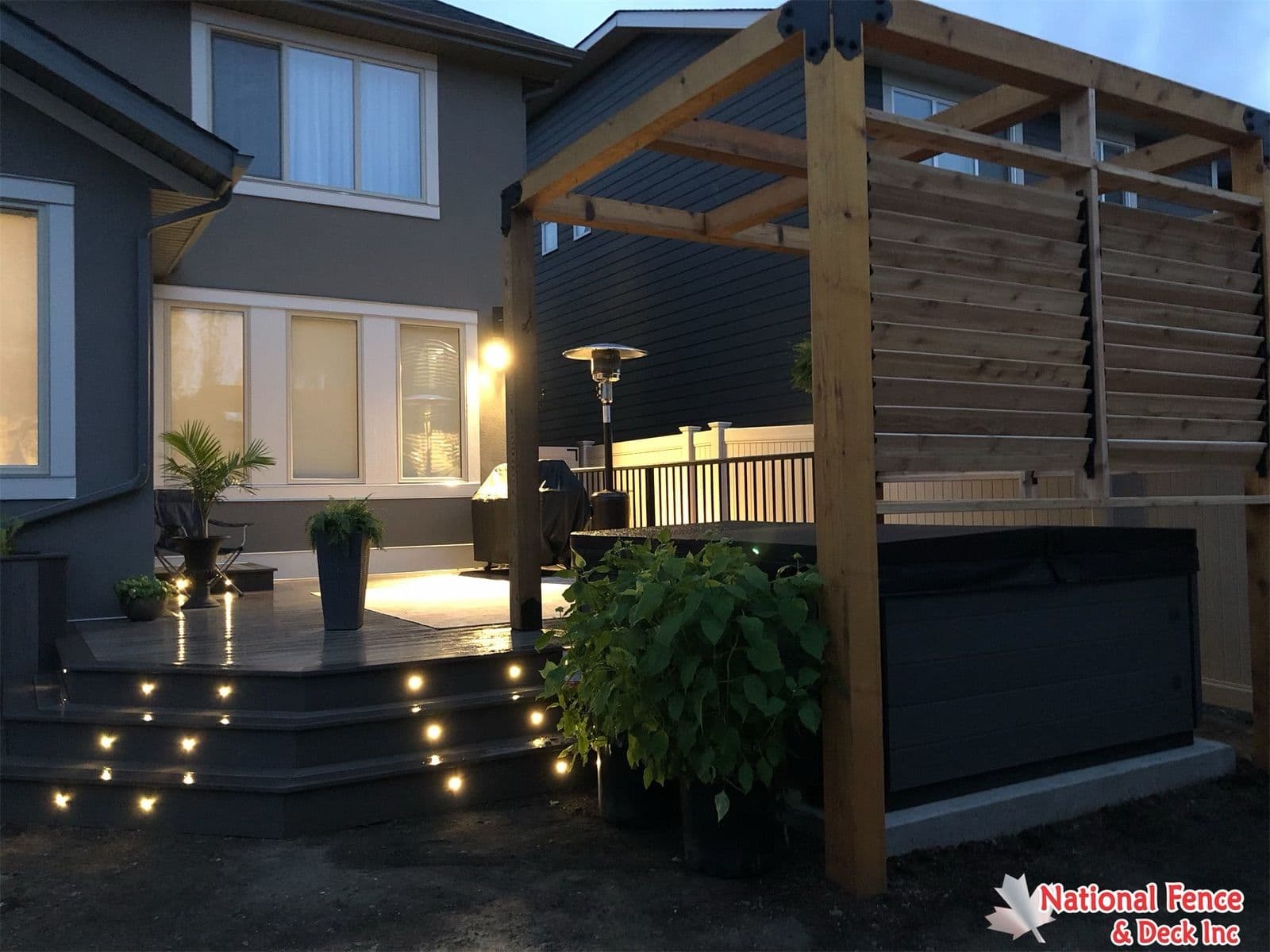 Modern Calgary backyard deck design with privacy wall and outdoor living space