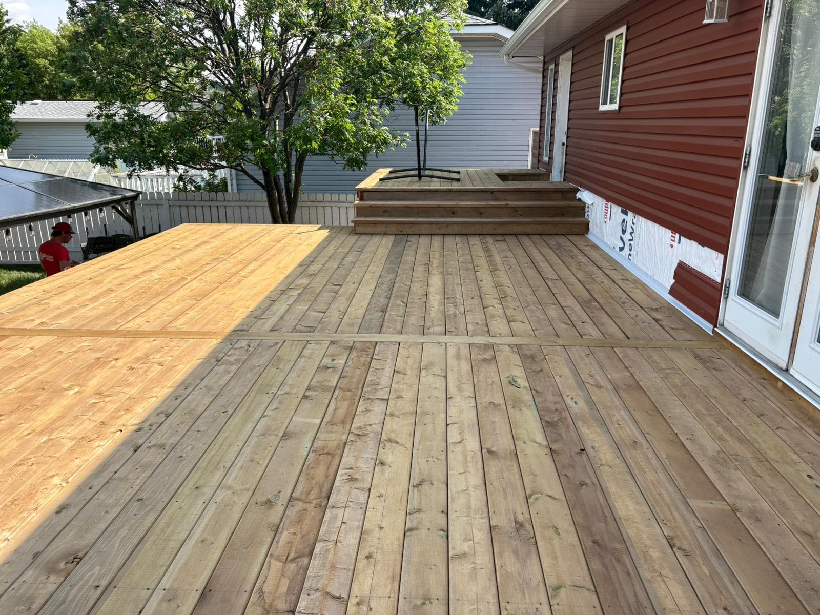 Pressure treated wood deck installation in Calgary backyard with multi-level layout
