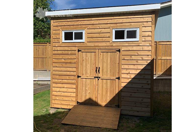 Custom built shed with cedar siding and door