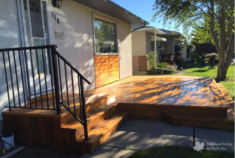 Cedar front landing and deck with matching wall cladding.