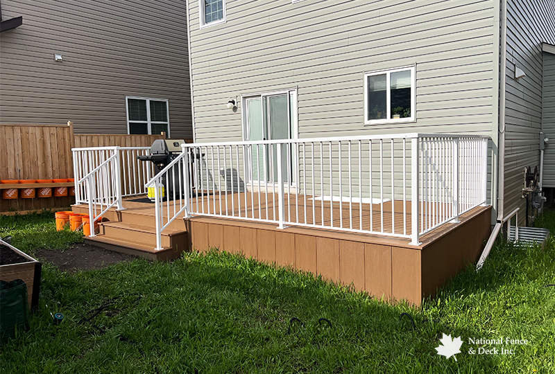 Trex Saddle deck with white aluminum picket railings.